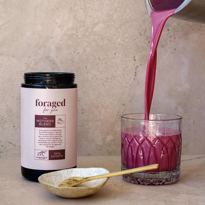 Foraged for You The Mothers Blend Powder powder and a prepared drink